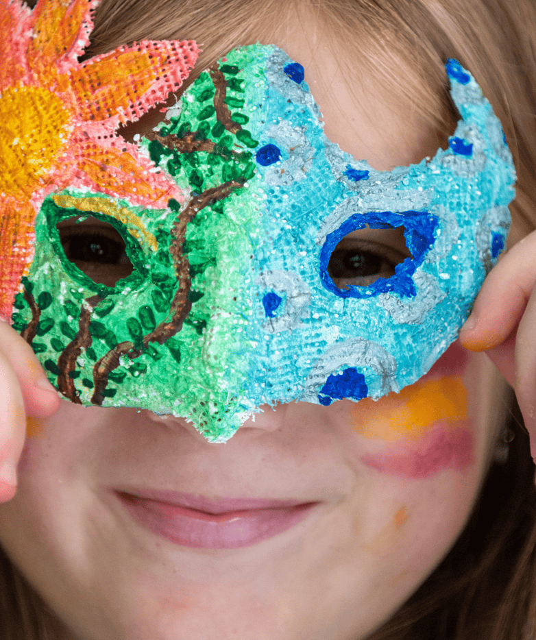 Brightly decorated carnival mask with colourful paint and artistic details in childhood festival.